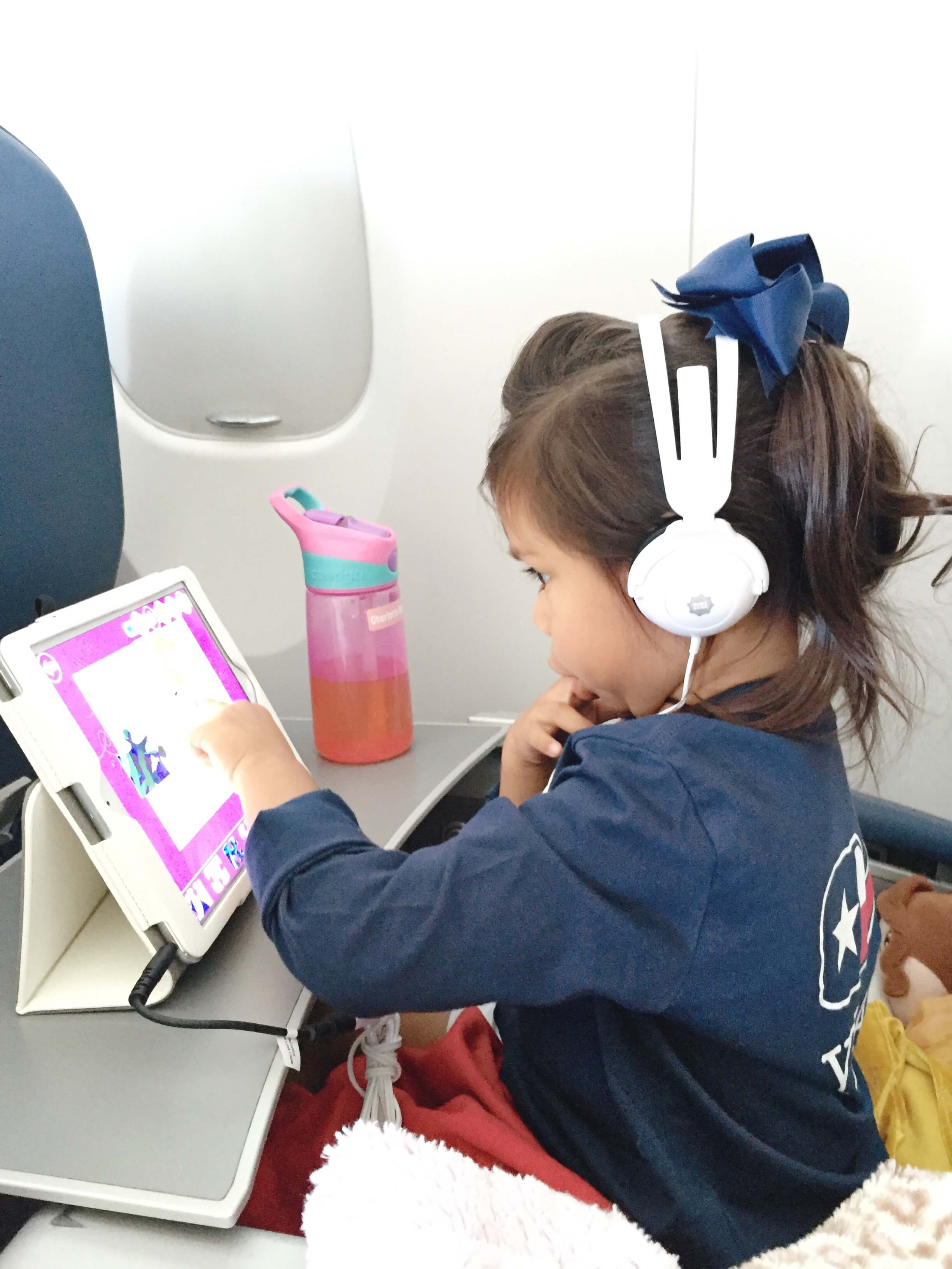 Pre-schooler flight essentials to help save your sanity. All the things you'll need in your child's carry-on bag and tips and tricks for flying with a young child. 
