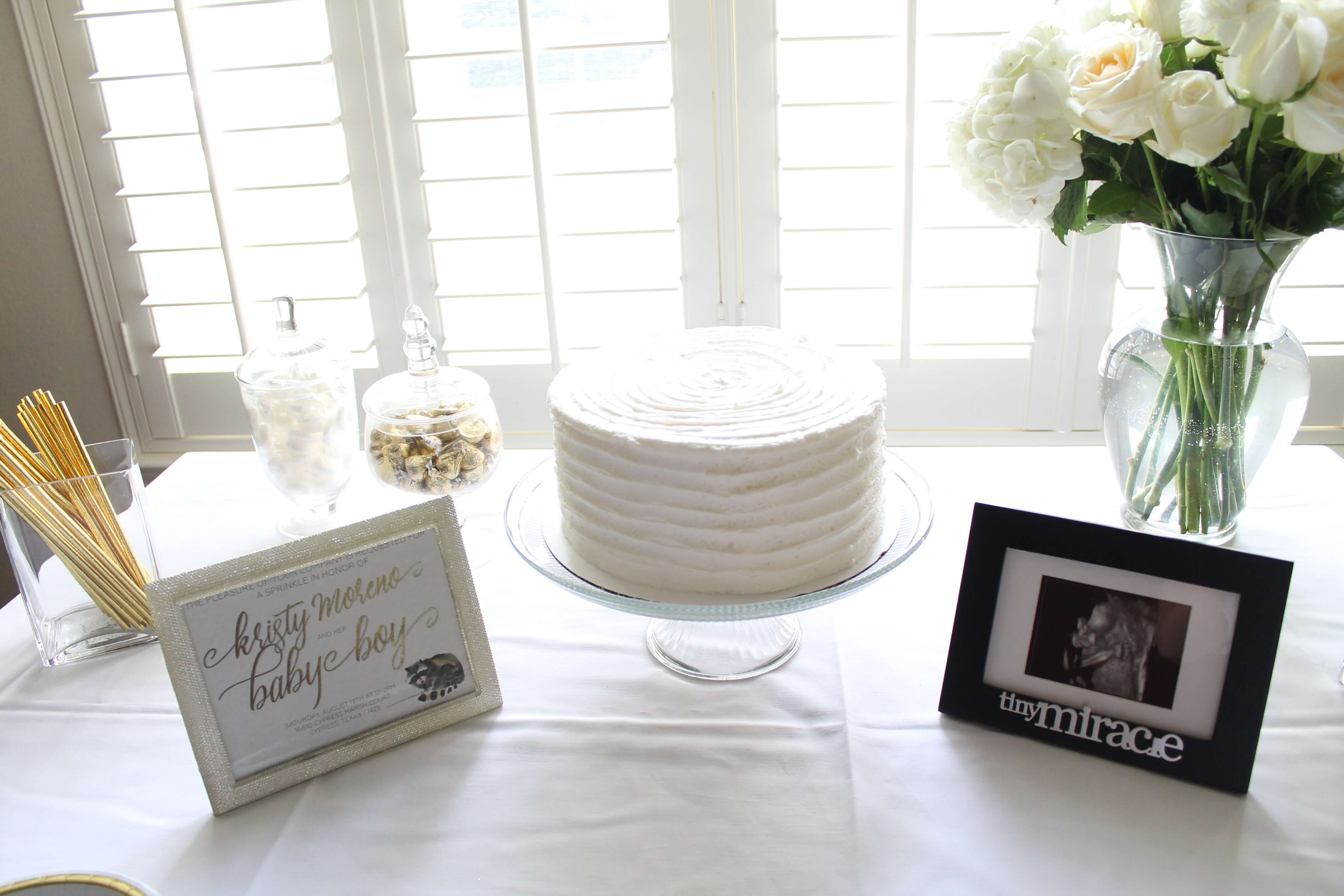 A gender neutral baby shower sprinkle. All the details from an elegant and simple shower in a color scheme of white, gray, and gold.