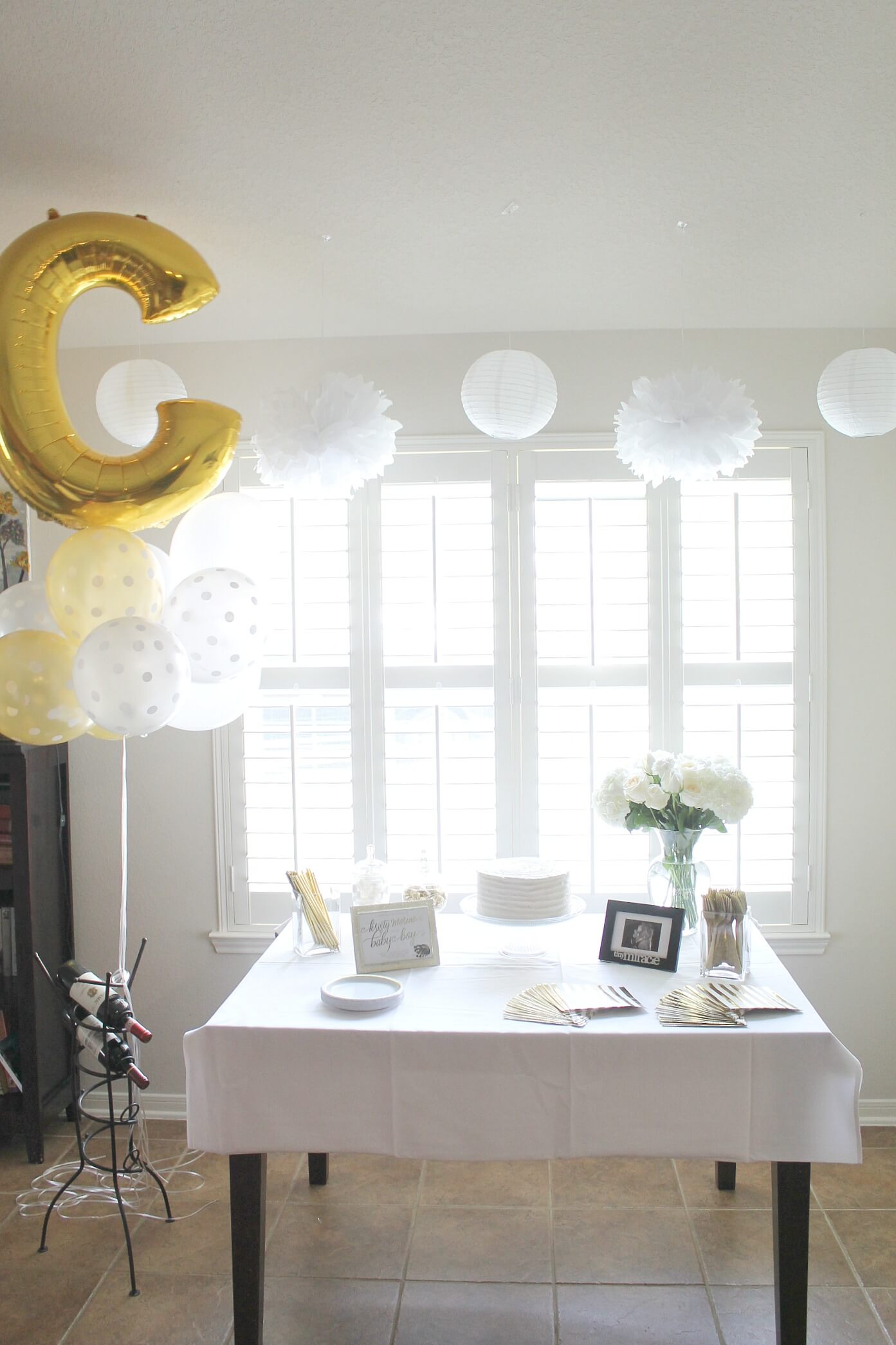 A gender neutral baby shower sprinkle. All the details from an elegant and simple shower in a color scheme of white, gray, and gold.