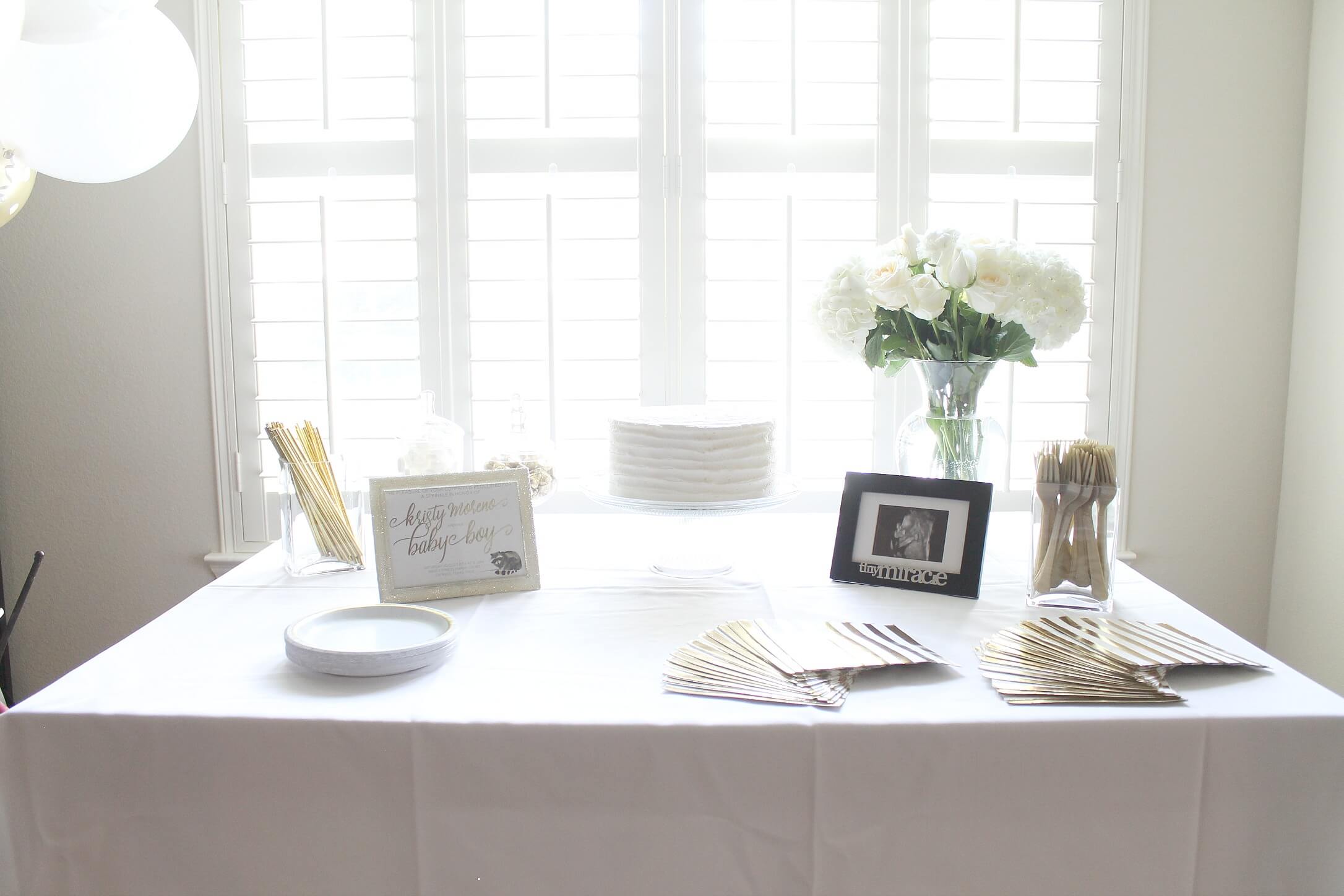 A gender neutral baby shower sprinkle. All the details from an elegant and simple shower in a color scheme of white, gray, and gold.