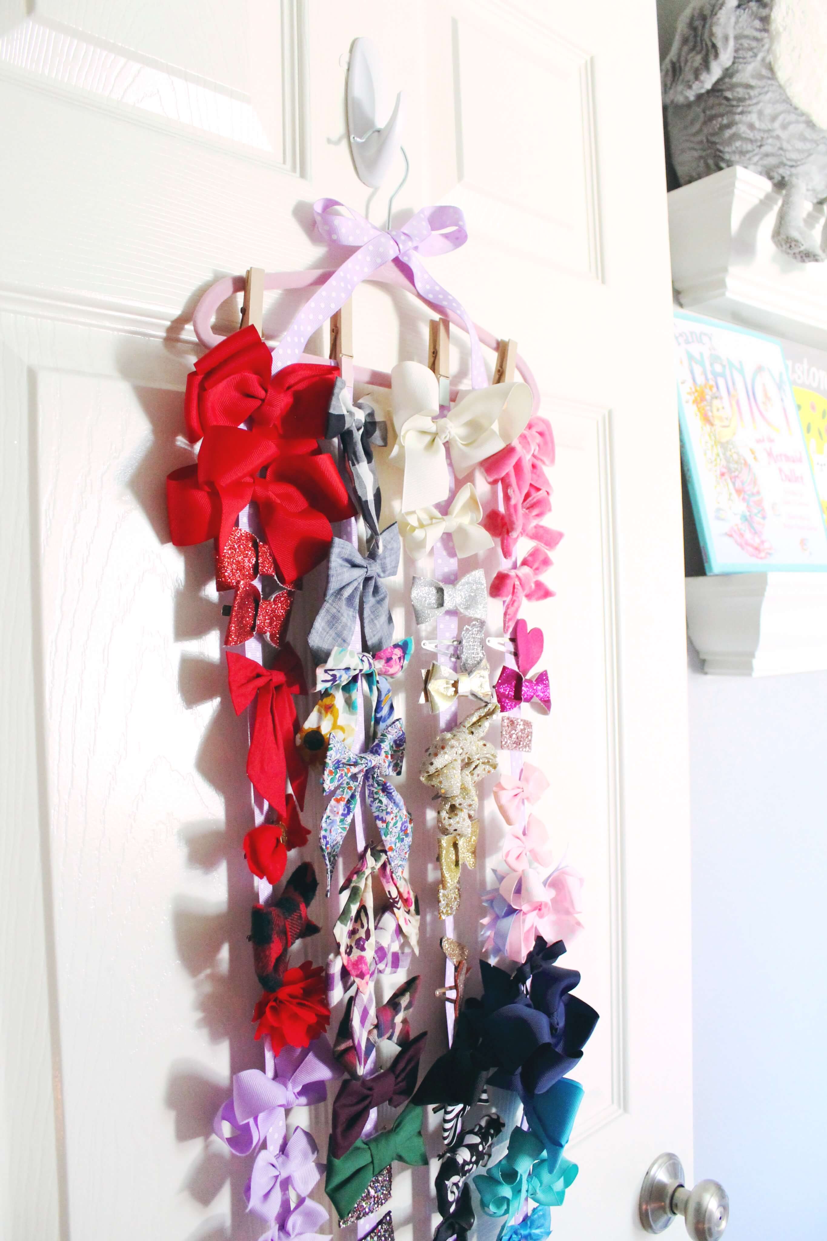The easiest DIY bow organizer to house all of your little girl's bow clips! You don't even need a hot glue gun for this DIY. So easy and cute!
